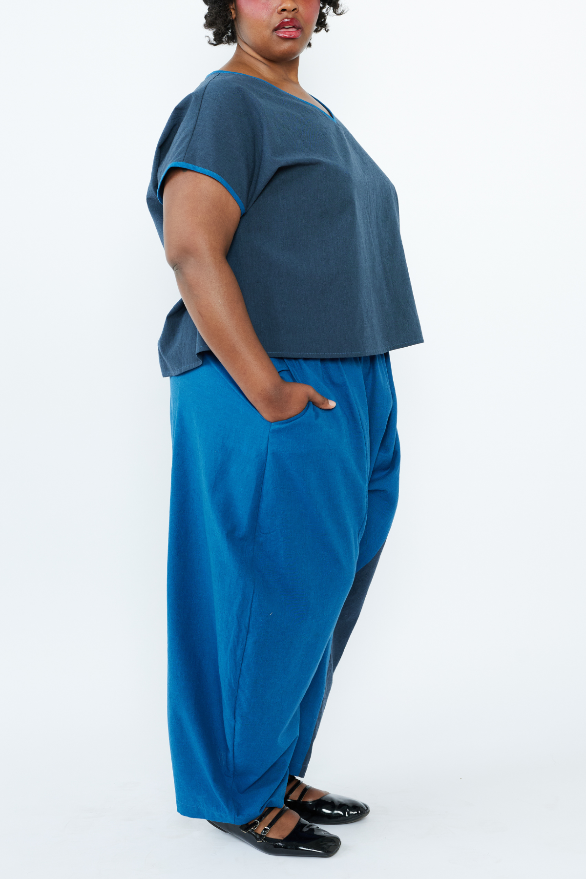 Person wearing a blue outfit with a plain background