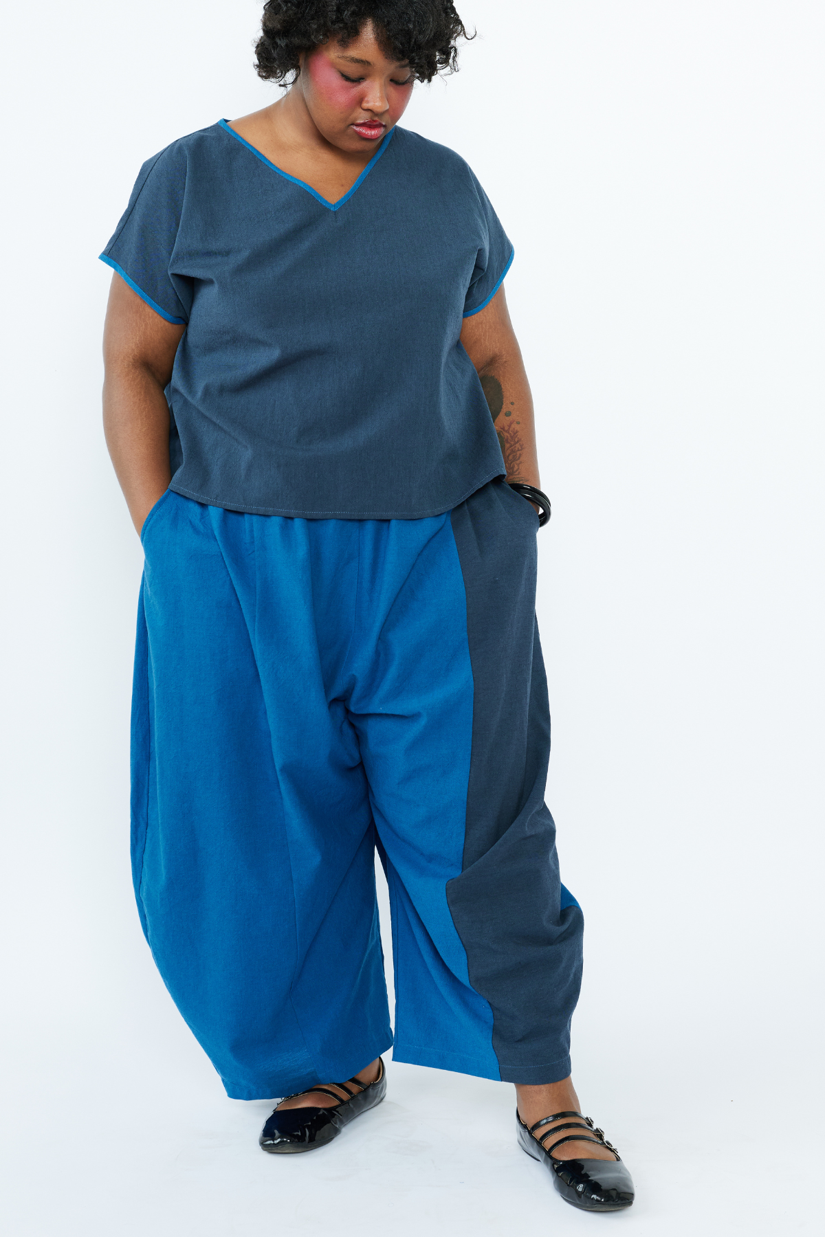 Person wearing a blue outfit with a white background