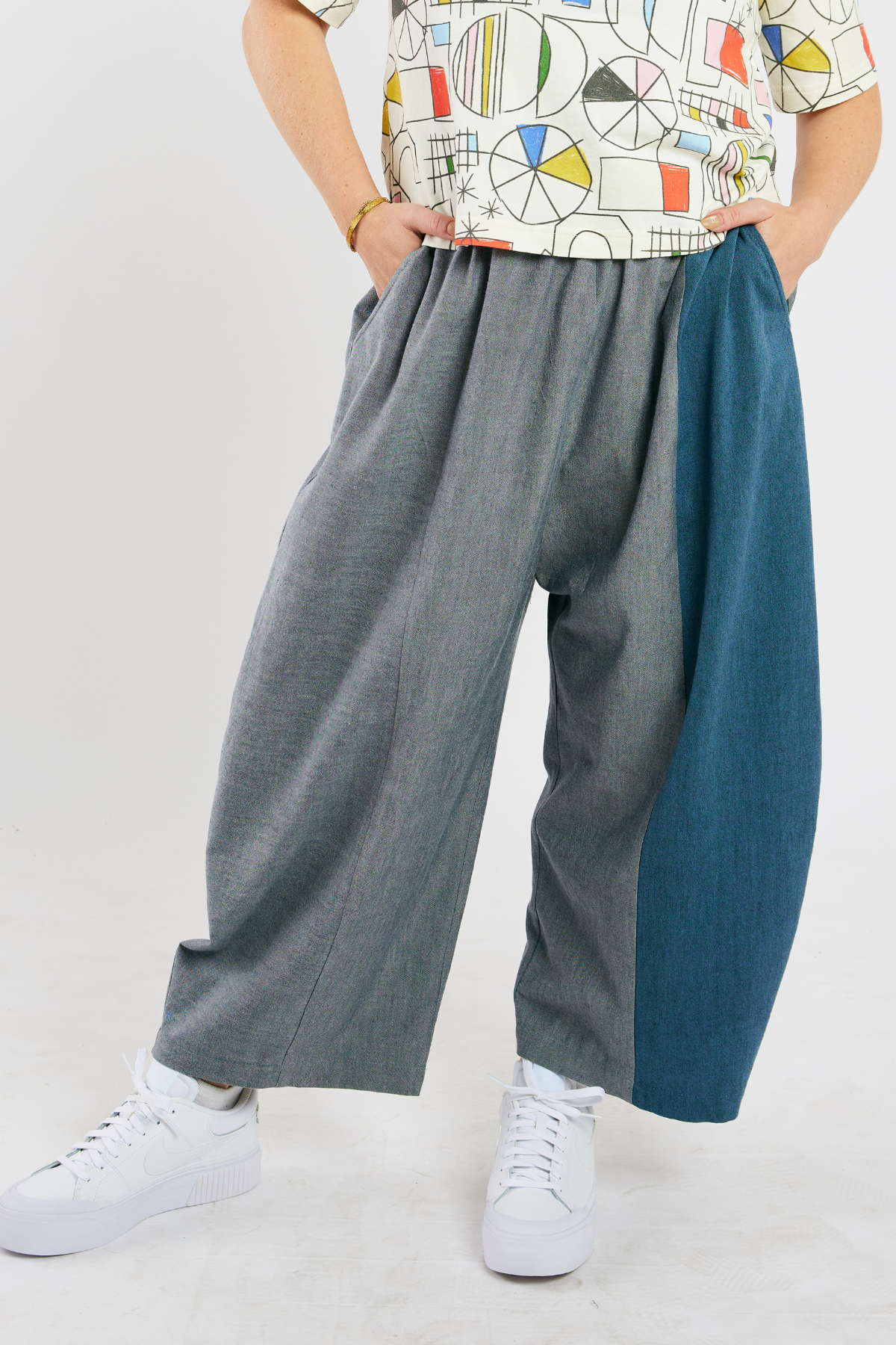 person wearing gray and blue barrel-leg pants made from sustainable bamboo and cotton. 