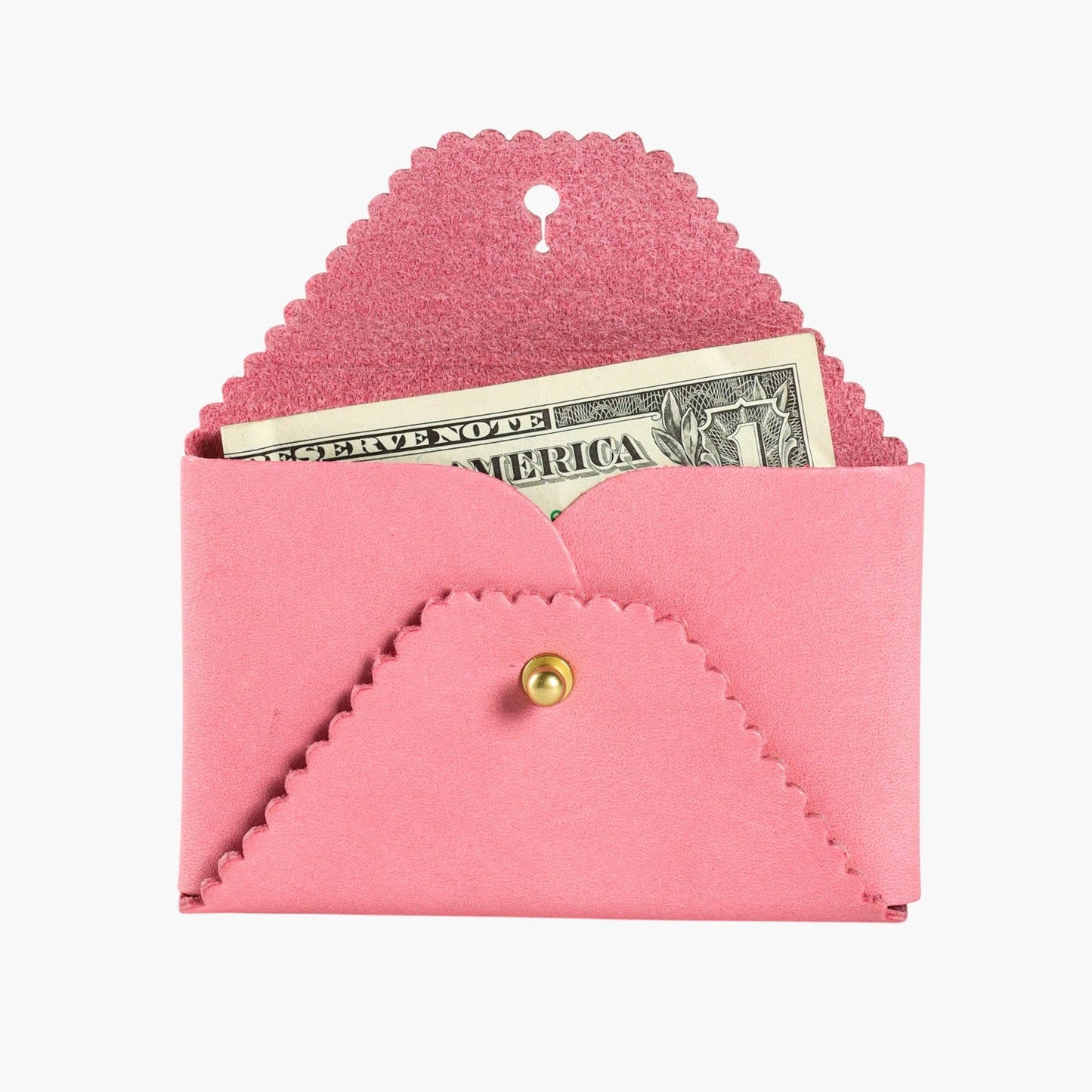 Pink envelope-shaped wallet with scalloped edges and a gold button, containing a dollar bill on a white background.