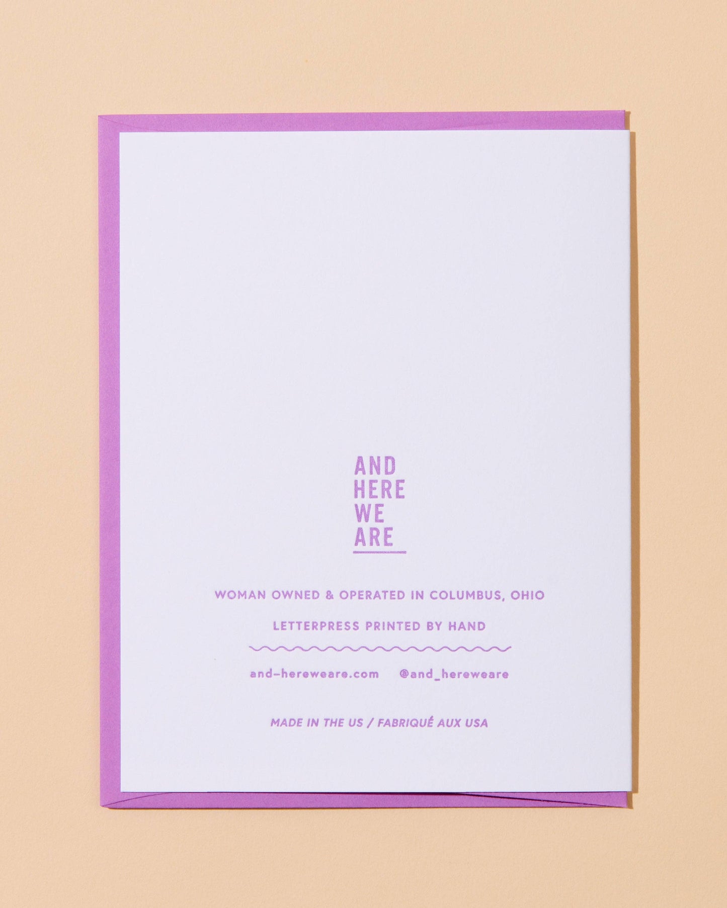 White card with purple border and text on a beige background