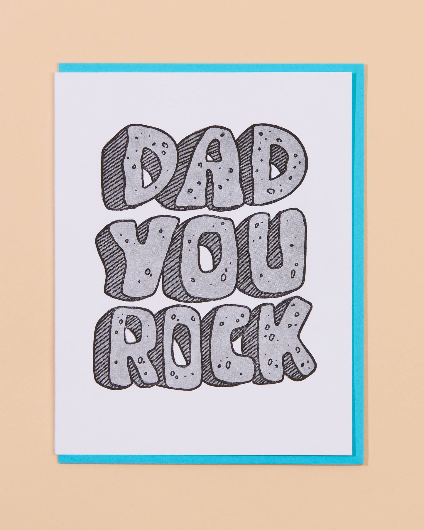 Card with 'Dad You Rock' text on a beige background