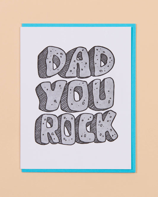 Card with 'Dad You Rock' text on a beige background