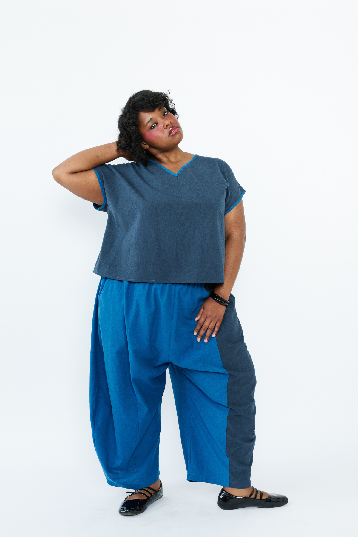 Woman wearing a blue outfit against a white background