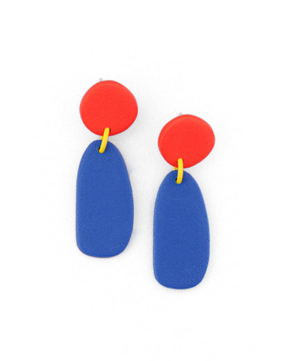 Pair of earrings with red circular tops and blue oval bottoms on a white background