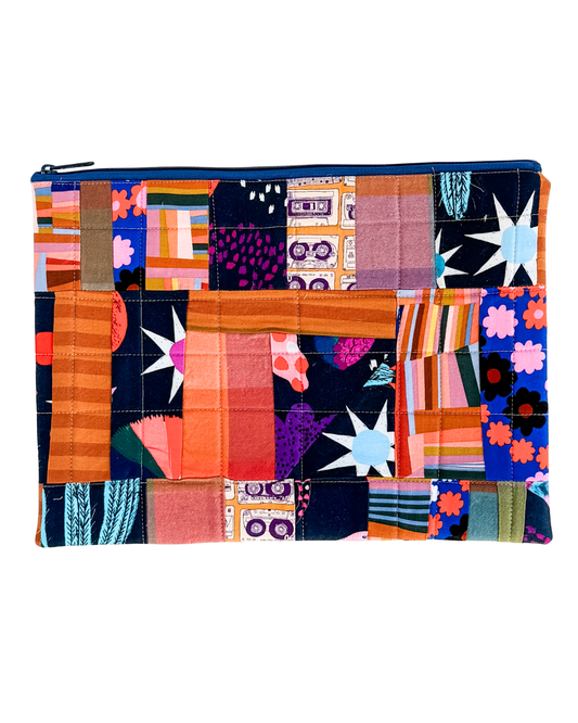 Colorful quilted laptop sleeve with a zipper on a white background