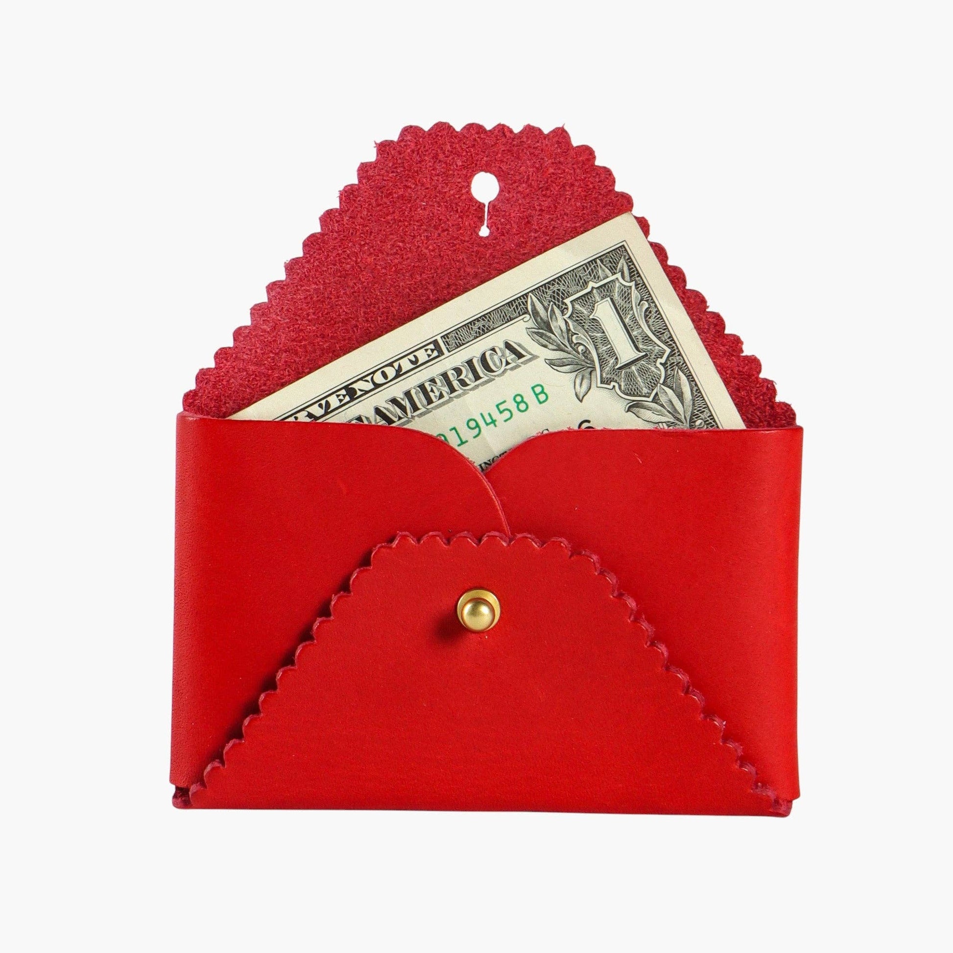 Red leather wallet with a button clasp containing a dollar bill on a white background