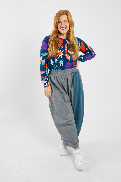 person wearing gray and blue barrel-leg pants with an elastic waist made from sustainable bamboo and cotton. 