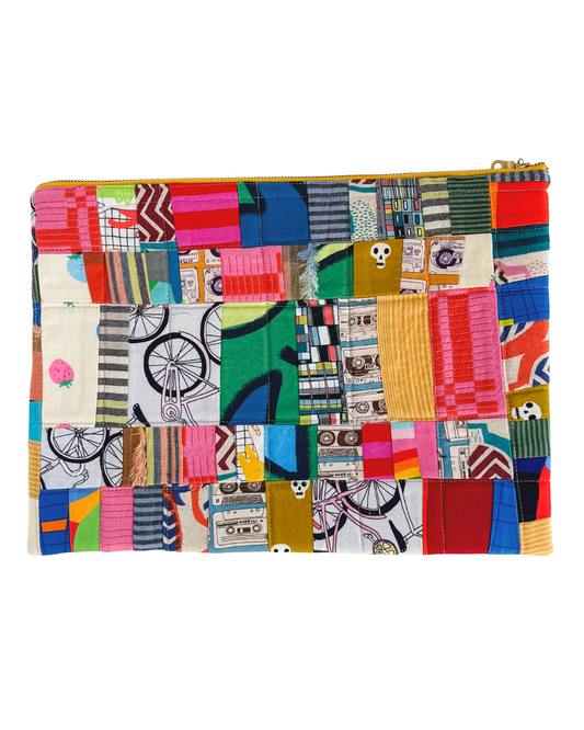 Multicolored quilted laptop pouch with zipper on a white background