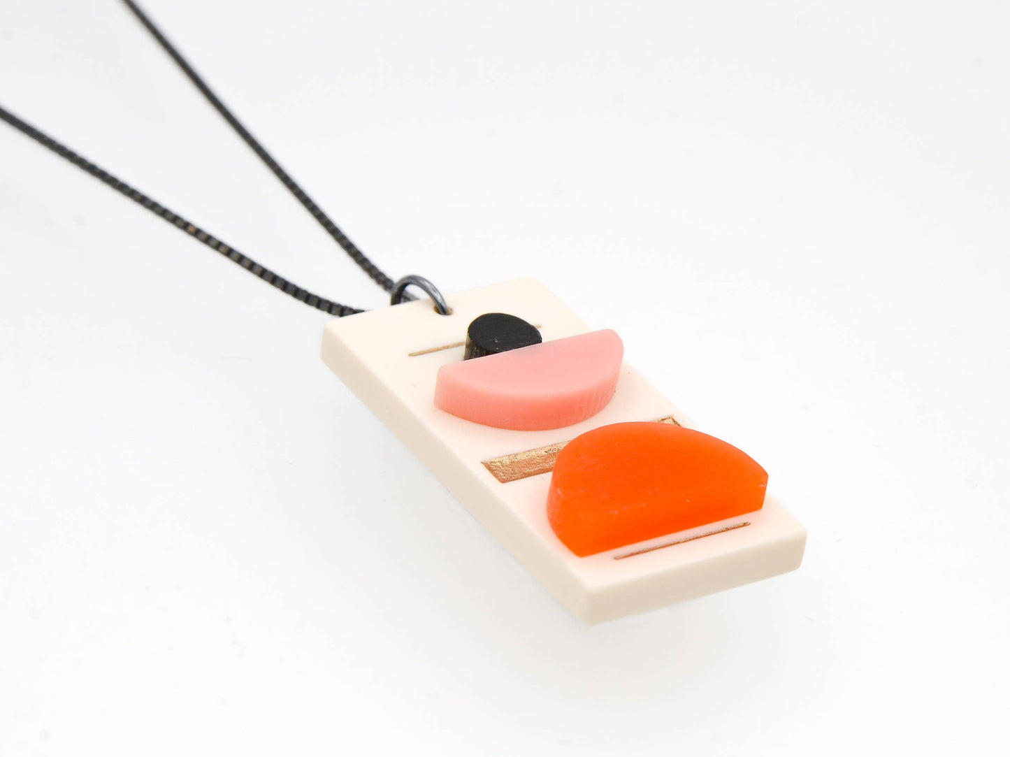 Necklace with a geometric pendant on a white background