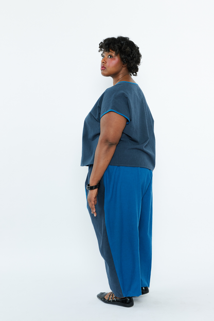 Person wearing a blue outfit with a plain white background
