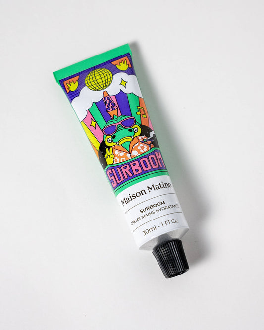 Colorful tube of floral hand cream on a white background
