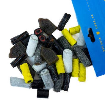 Assorted black licorice gummy candies in black, white, and yellow on a white background with a blue box.