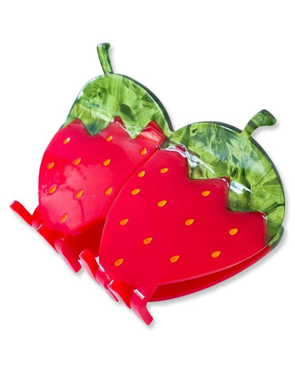 Strawberry-shaped cellulose hair clip on a white background