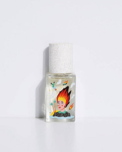 A clear glass bottle of perfume with a white cap and a label featuring a flame graphic and text.