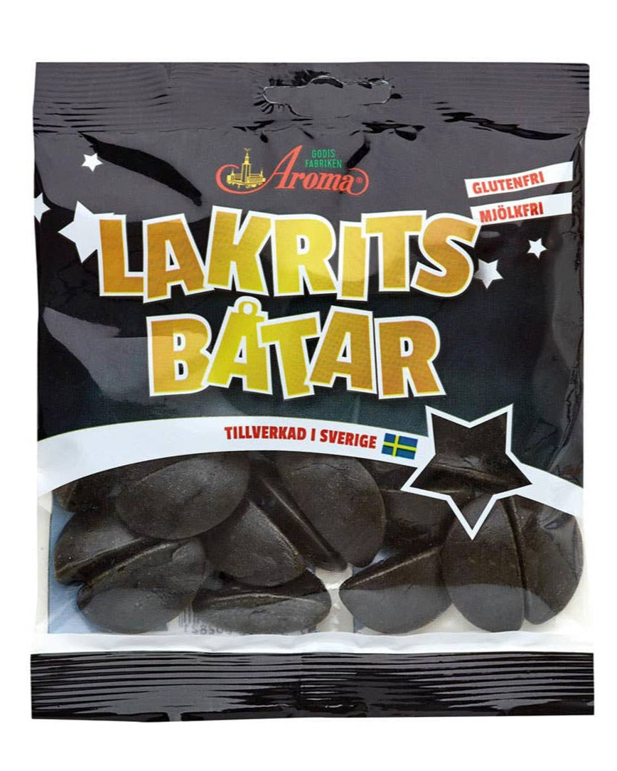 A package of Aroma brand Lakritsbåtar, which are licorice boats. The package is predominantly black with gold and white text, and features an image of the licorice product.