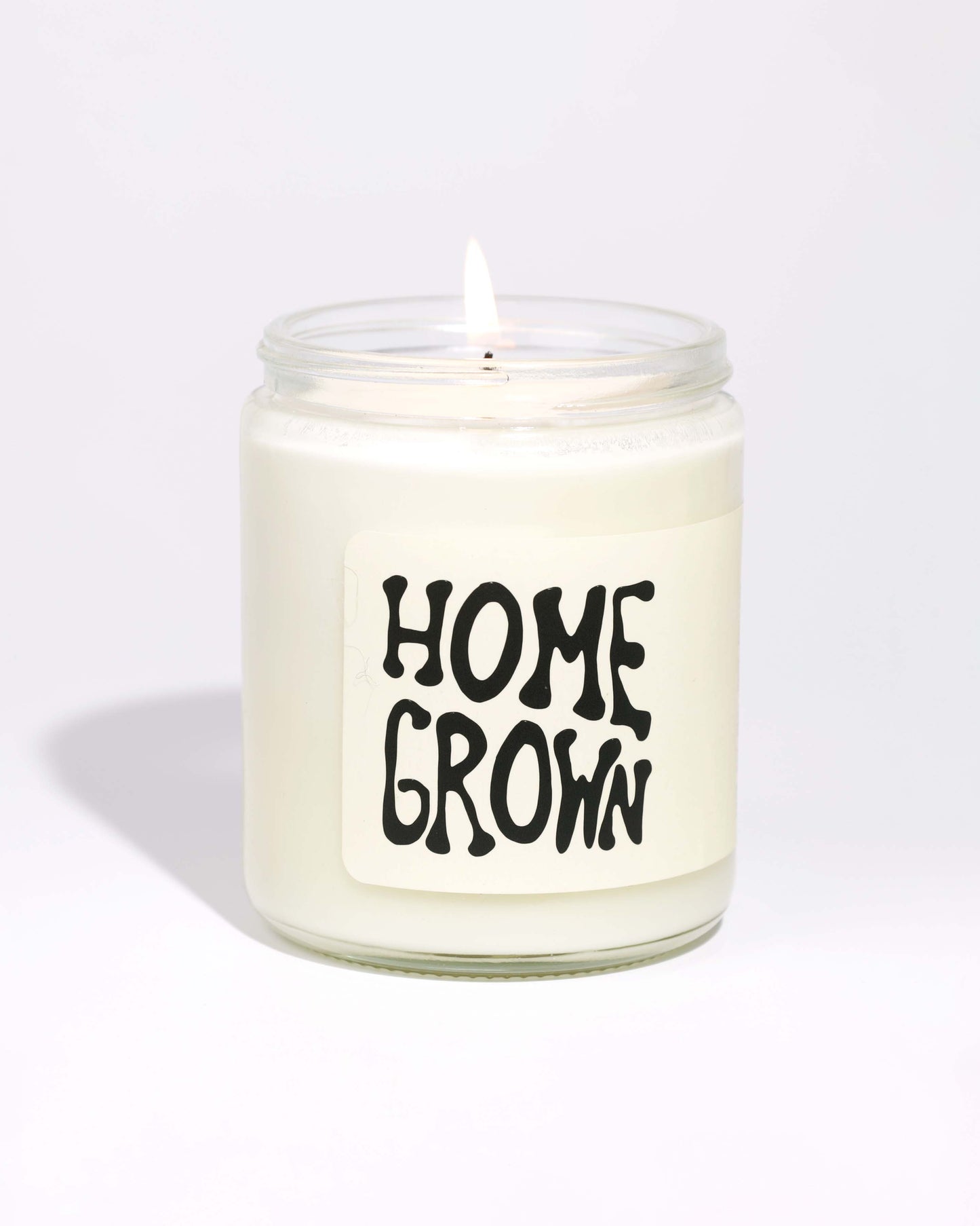 Soy Candle in a glass jar with 'HOME GROWN' label on a white background