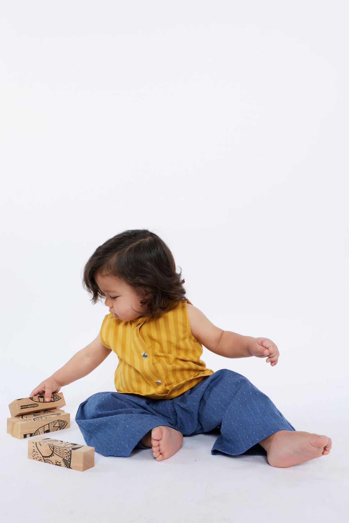 Child playing with wooden blocks on a white background