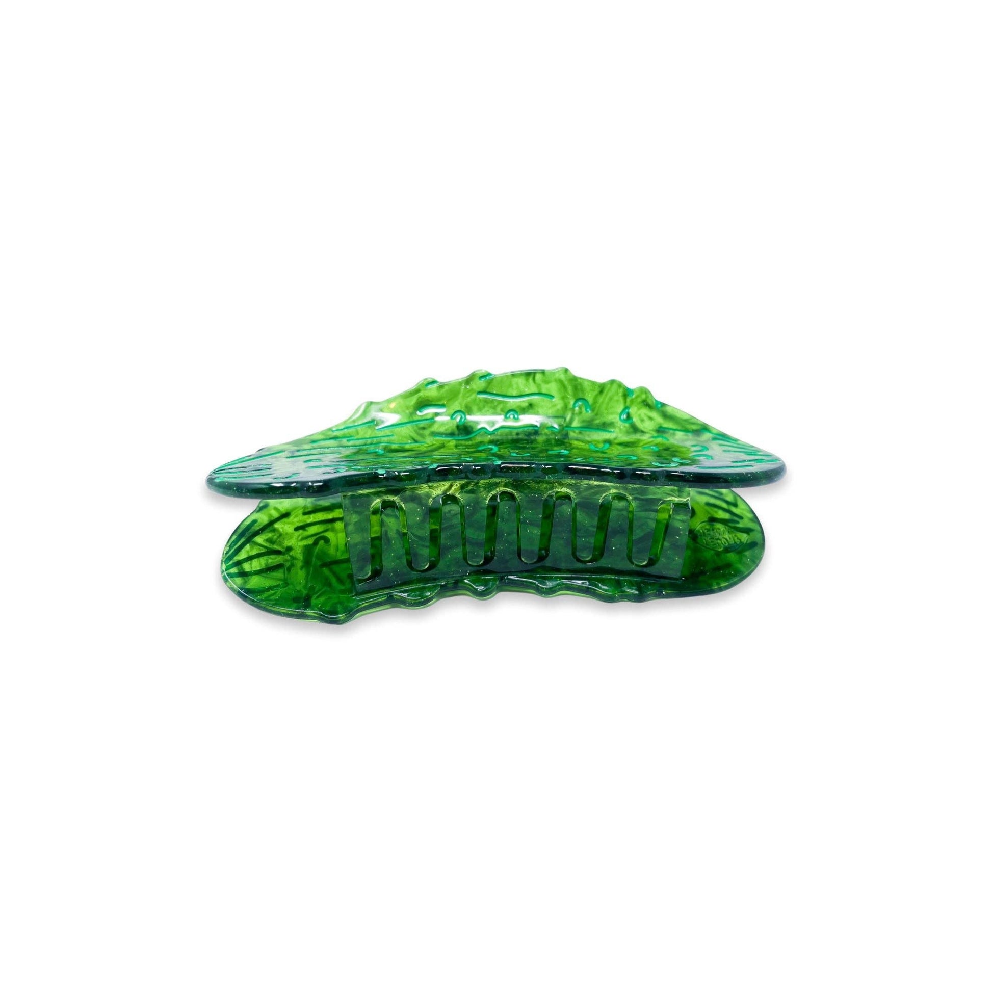 Green pickle hair clip on a white background