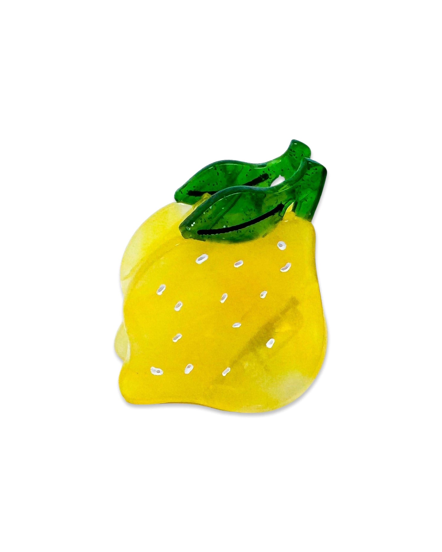 A yellow hair claw clip designed to resemble a lemon, with green accents for the stem and leaves.