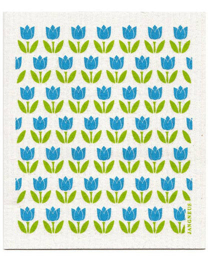 A white Swedish dishcloth with a green and blue floral pattern of tulips, designed by Jangneus in Sweden.