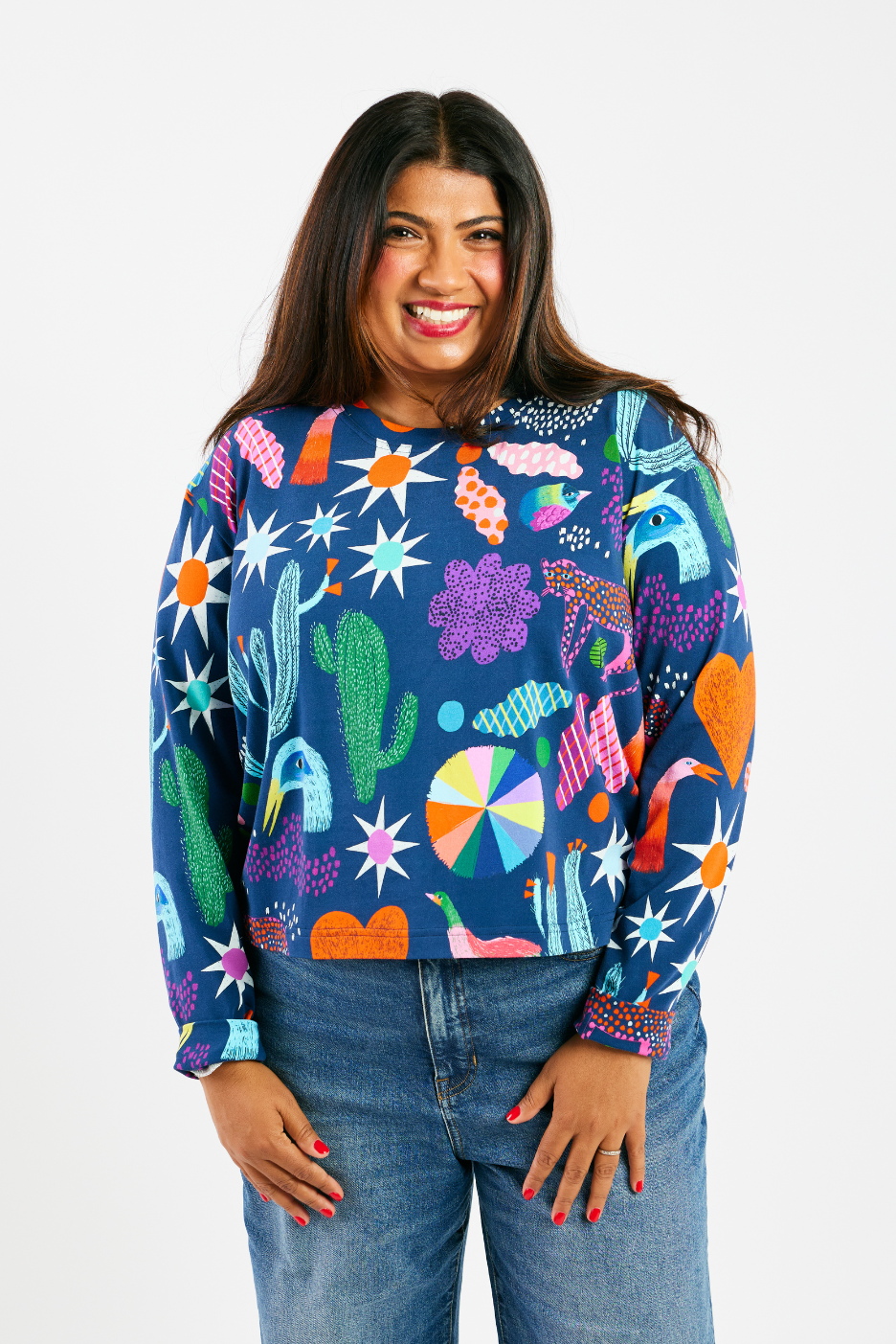 Woman wearing an ethically-made colorful shirt and jeans.  