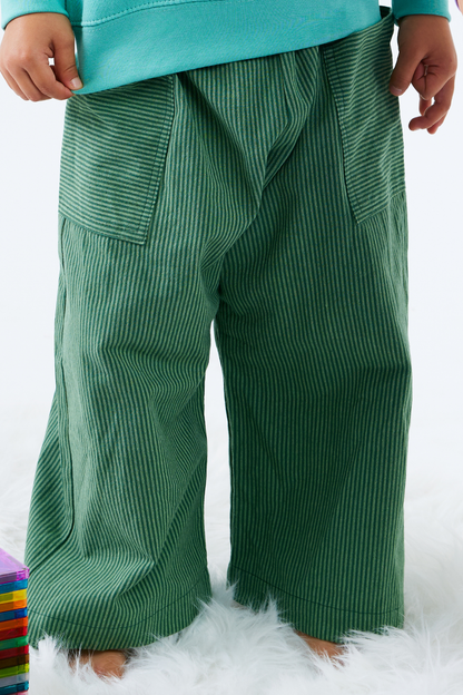 Green stripe cotton pants worn by a child on a white background