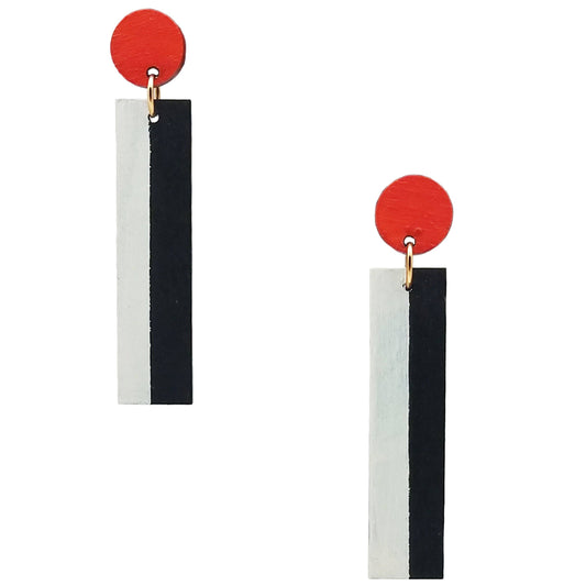 A pair of geometric drop earrings featuring a vibrant red circular top, a small gold ring, and a vertical rectangular bar split down the middle into white and black sections.