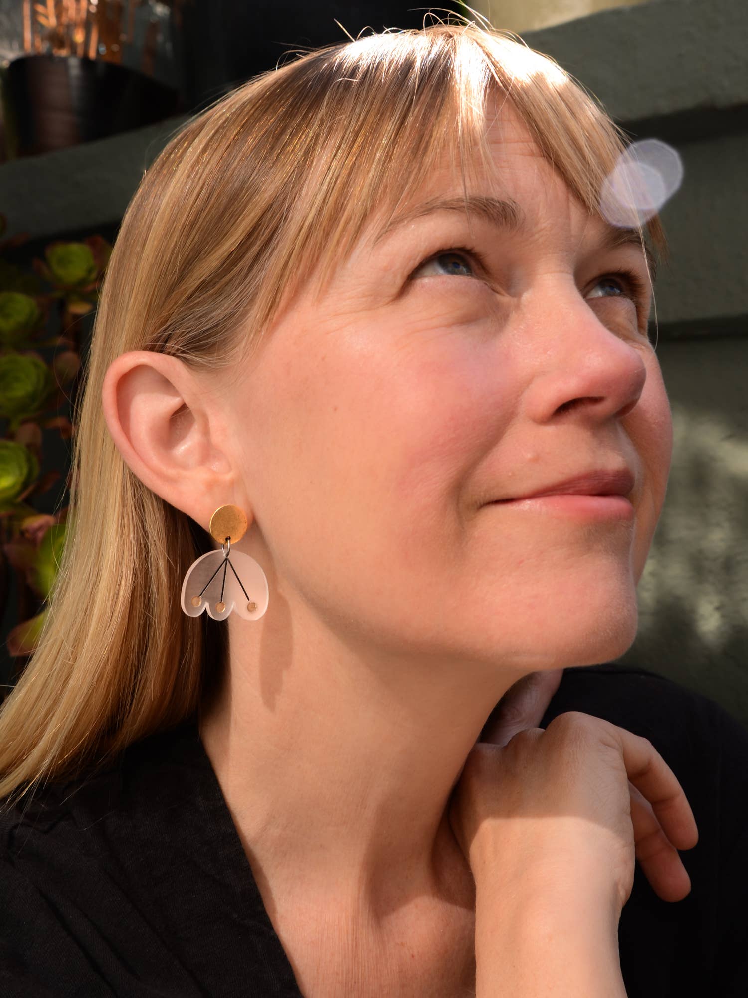 Woman wearing a unique earring with a blurred background