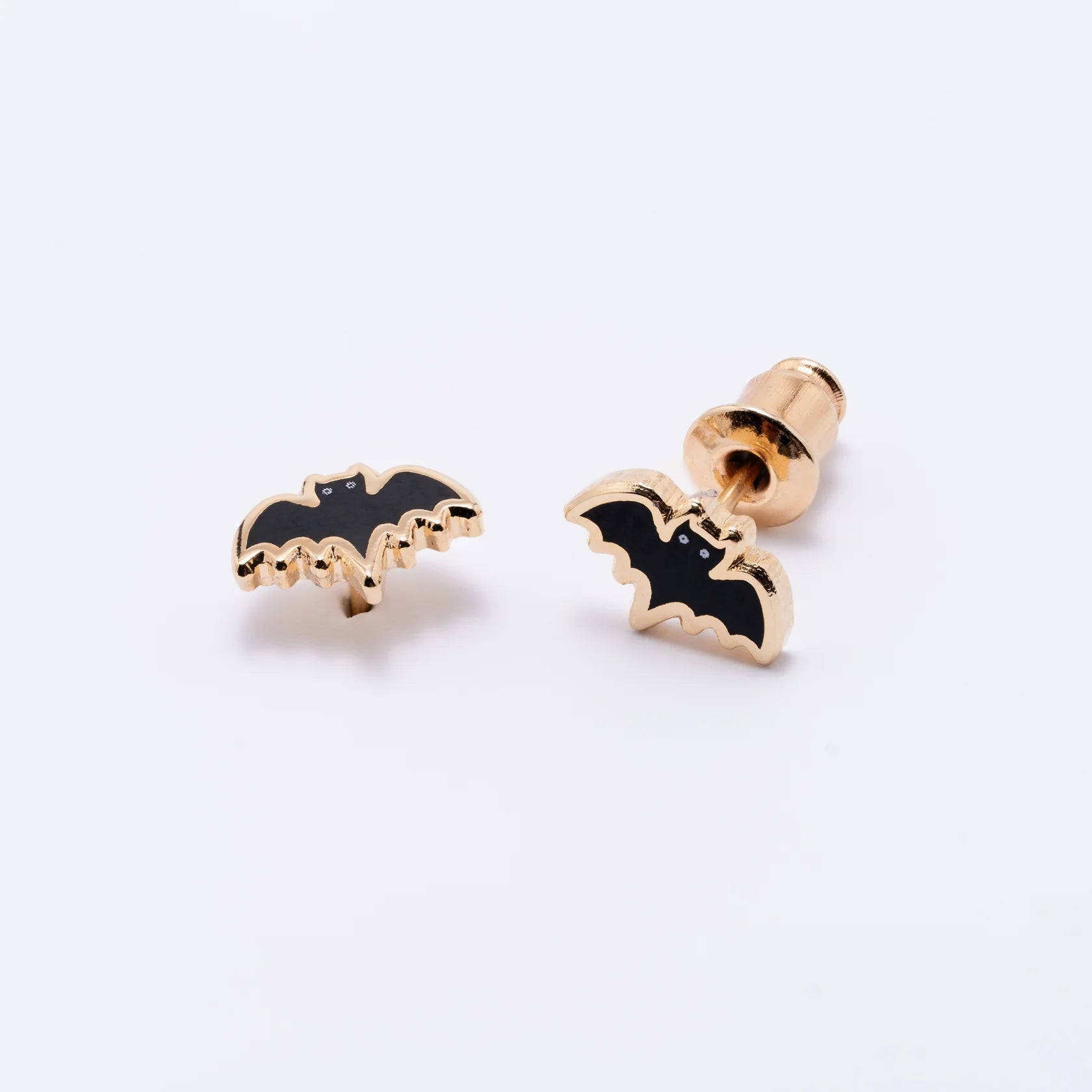 Bat-shaped earrings on a white background