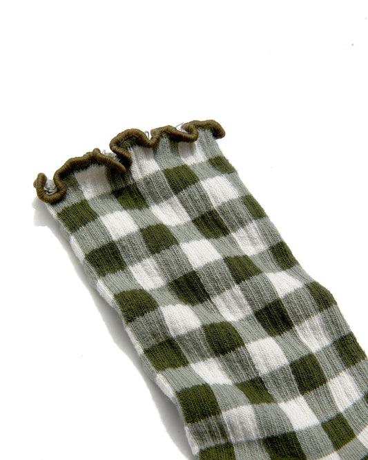 close up of Green and white checkered ruffle sock with brown trim on a white background