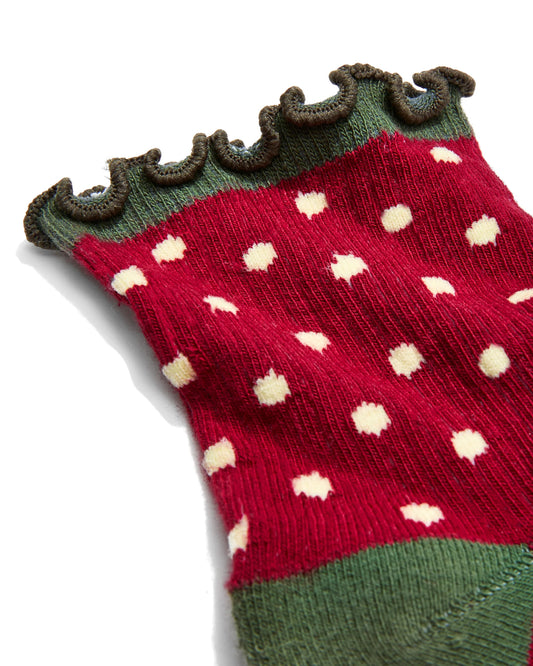 Knitted sock with strawberry pattern on a white background