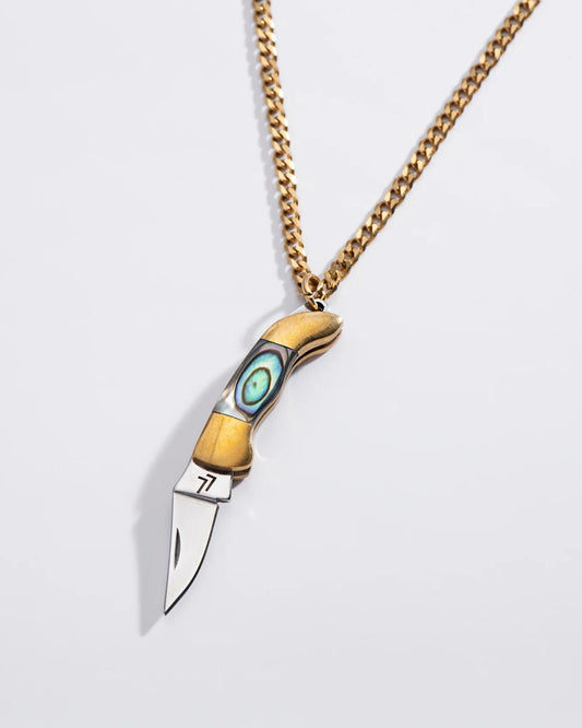 A necklace with a switchblade pendant, featuring a long gold-colored chain and a knife with a blue and white handle.