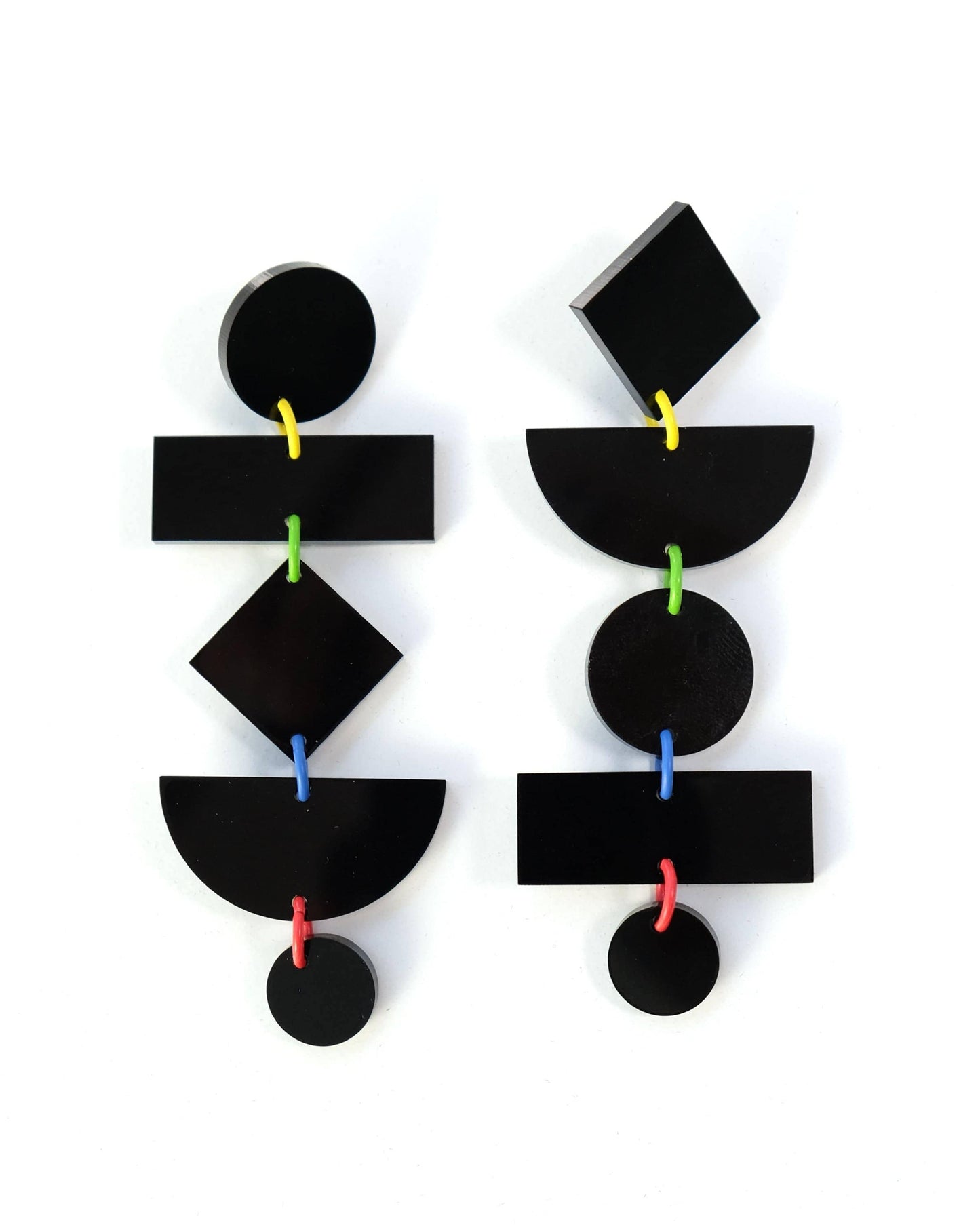 Black geometric earrings on a white background