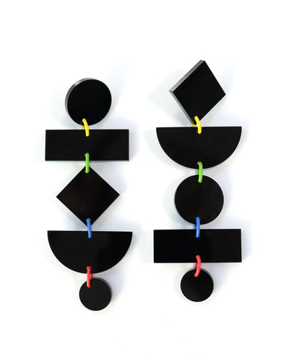 Black geometric earrings on a white background