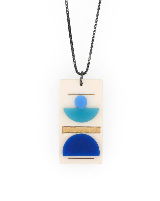 Necklace with a rectangular pendant featuring blue and beige geometric shapes on a white background