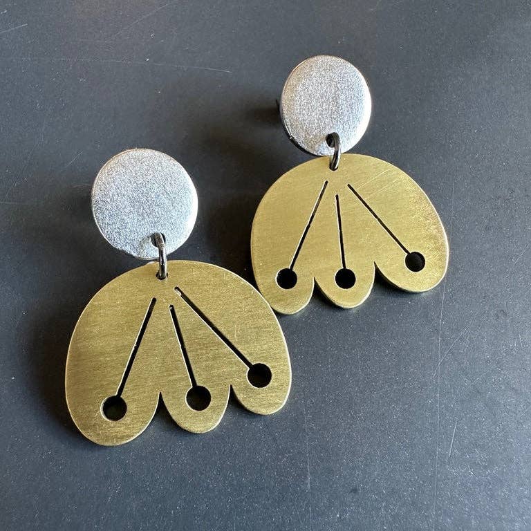 Pair of Scandinavian floral gold and silver earrings on a dark background