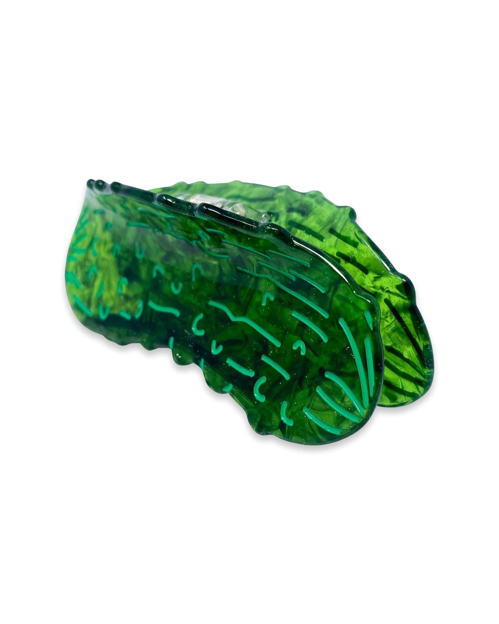 Pickle-shaped hair claw slip on a white background