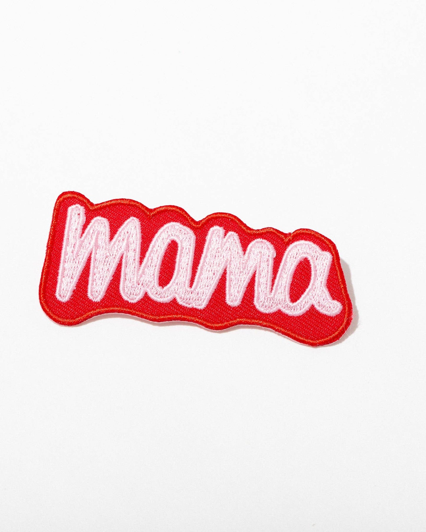 Embroidered patch with 'mama' text on a white background