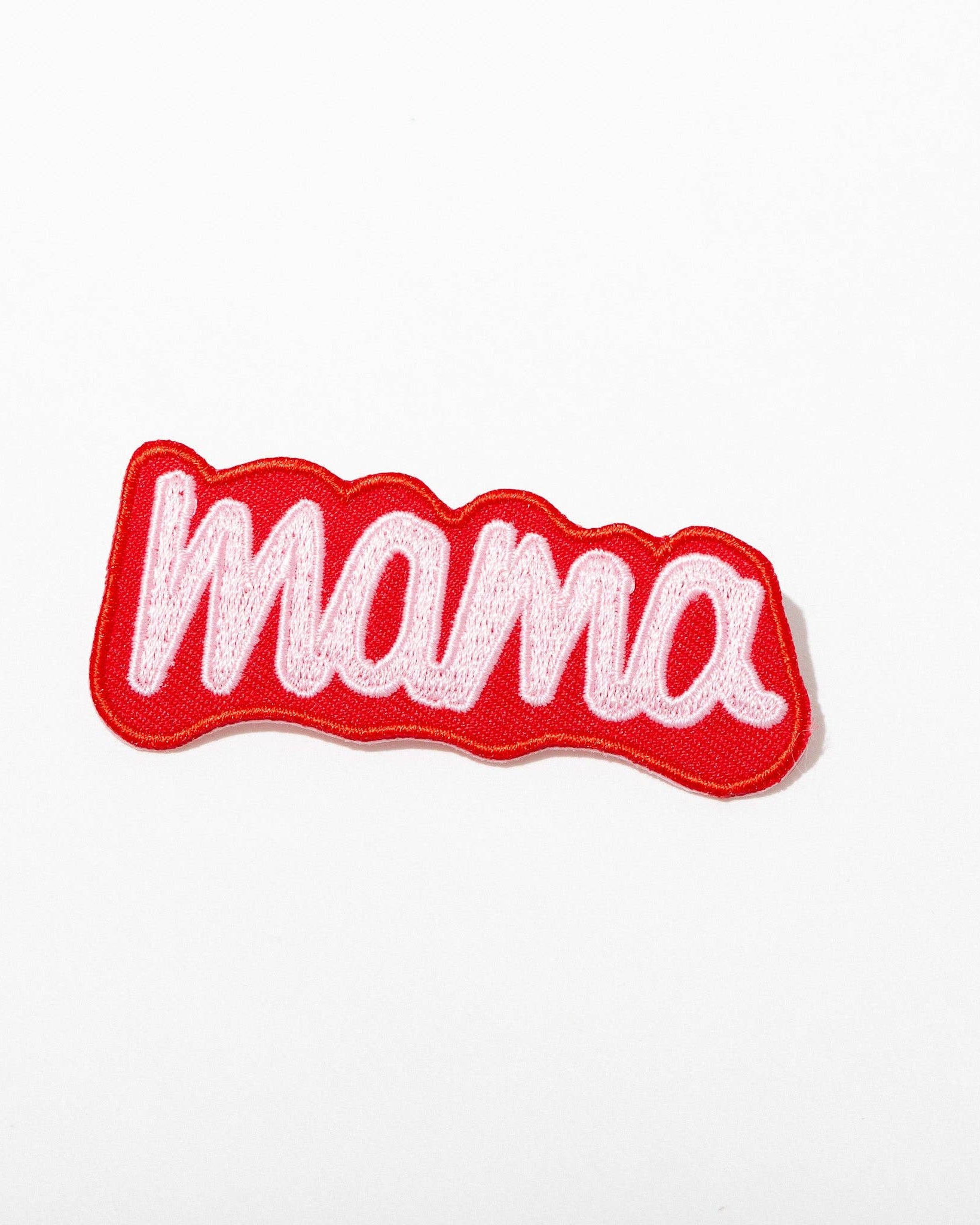 Embroidered patch with 'mama' text on a white background