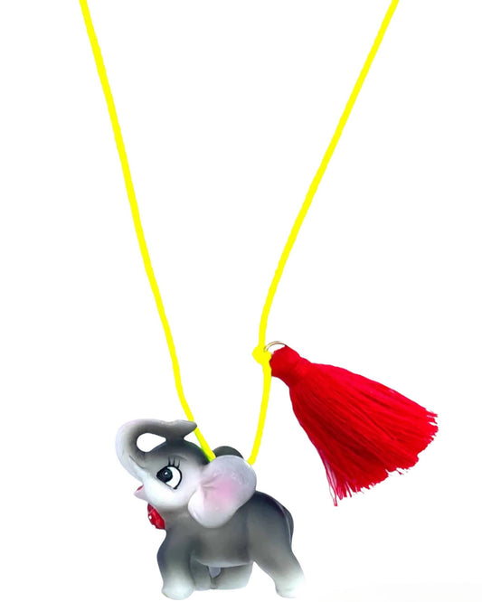 elephant necklace  with a red tassel on a yellow string against a white background