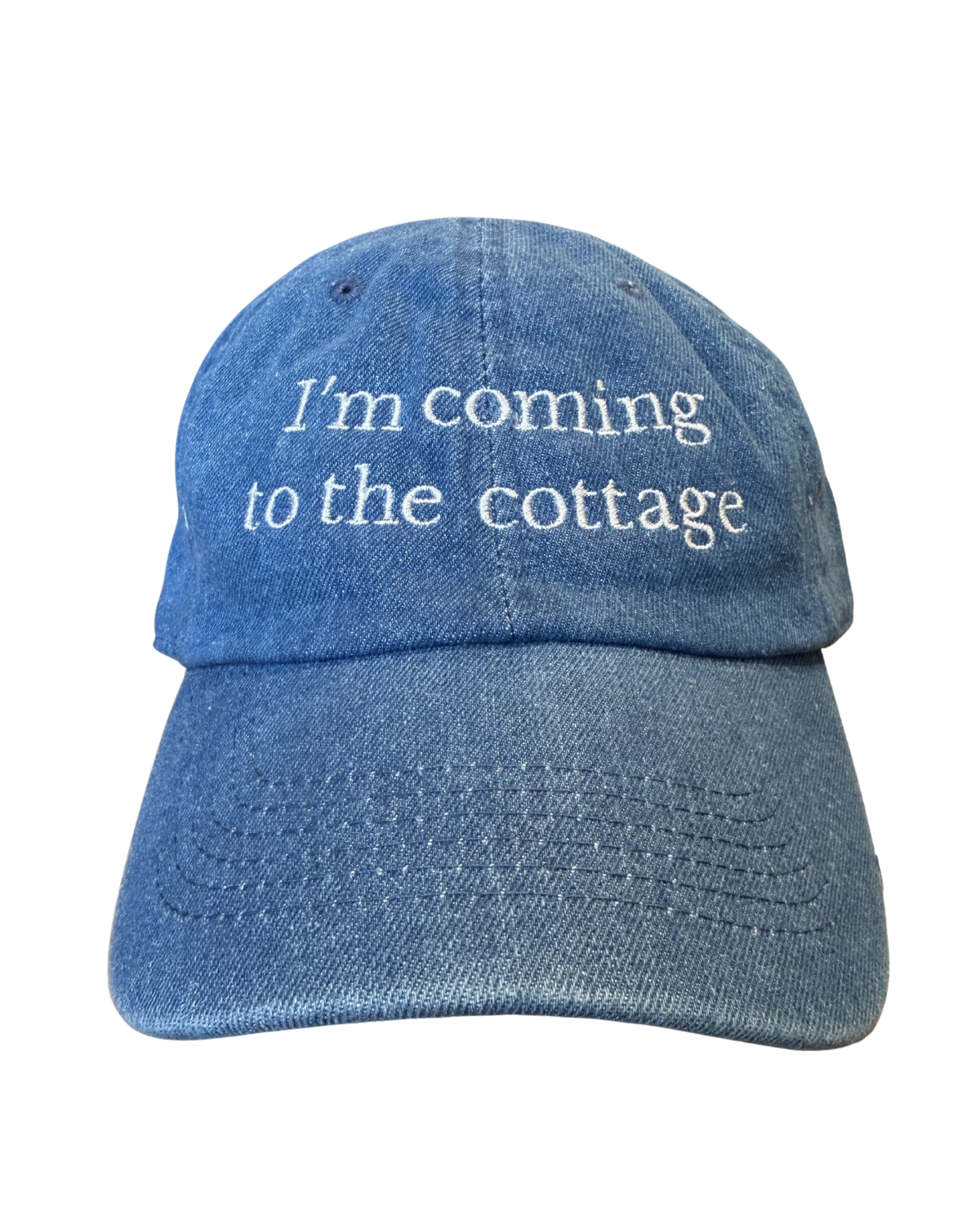 Blue denim cap with 'I'm coming to the cottage' text on a white background