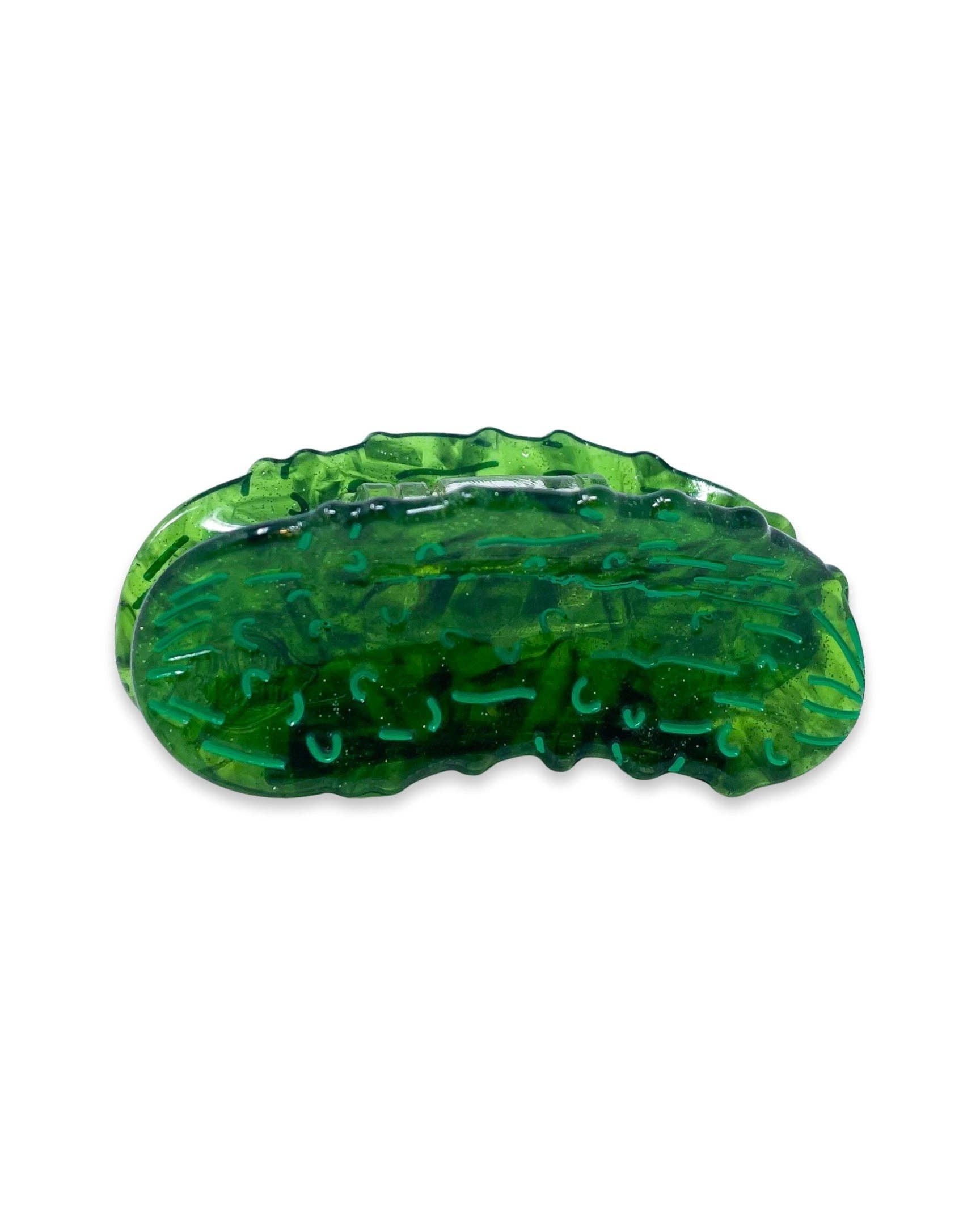 Green plant-based mini hair clip shaped like a pickle on a white background