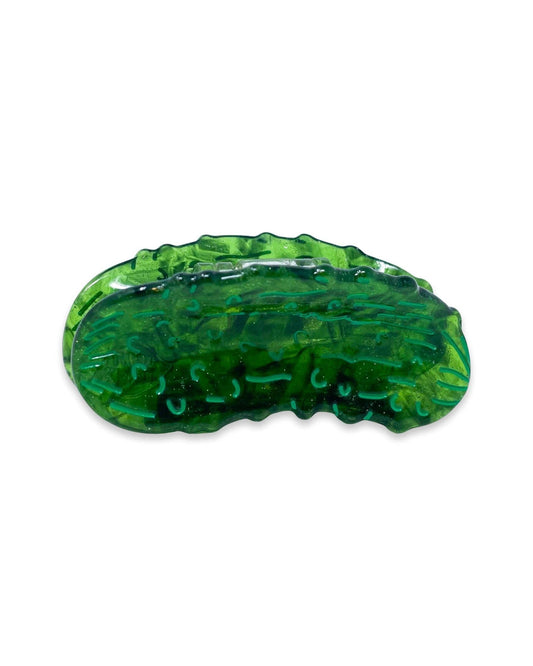 Green plant-based mini hair clip shaped like a pickle on a white background