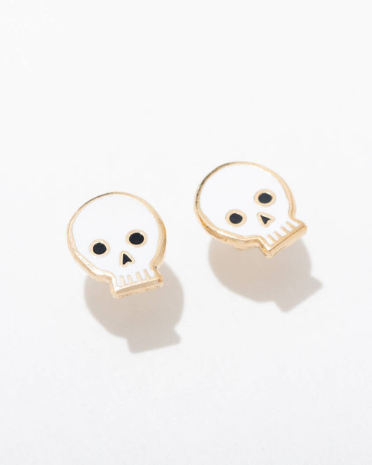 Skull-shaped earrings on a light gray background