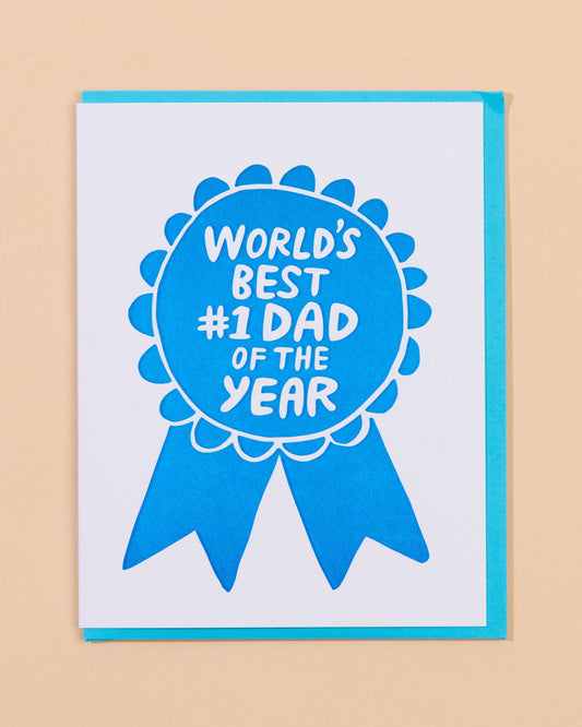 Card with blue ribbon design and text 'World's Best #1 Dad of the Year' on a beige background