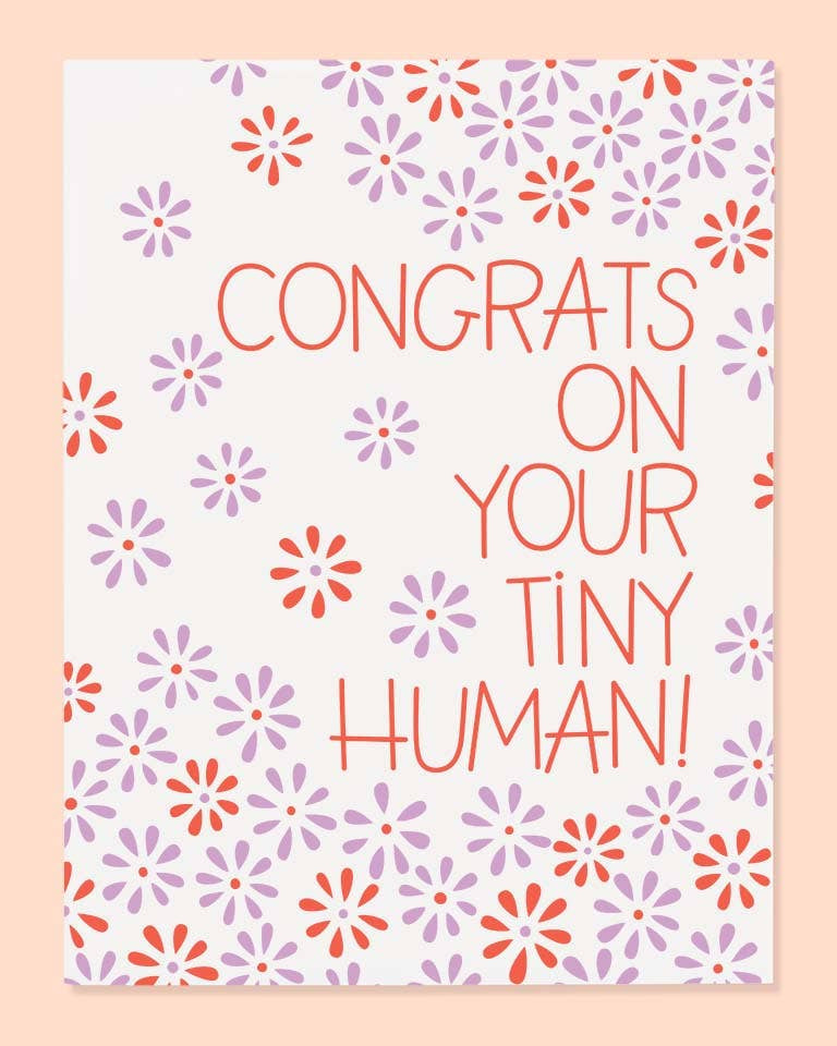 Greeting card with floral pattern and text 'Congrats on your tiny human!' on a light pink background
