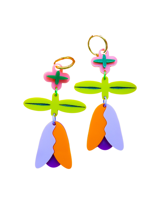 A pair of colorful, abstract flower-shaped dangle earrings on a solid white background. The earrings feature lime green petals, pink and green accents, orange and purple lower petals, and gold-tone screw-back rings.