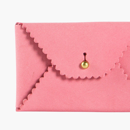Pink envelope-shaped leather wallet with a gold clasp on a white background