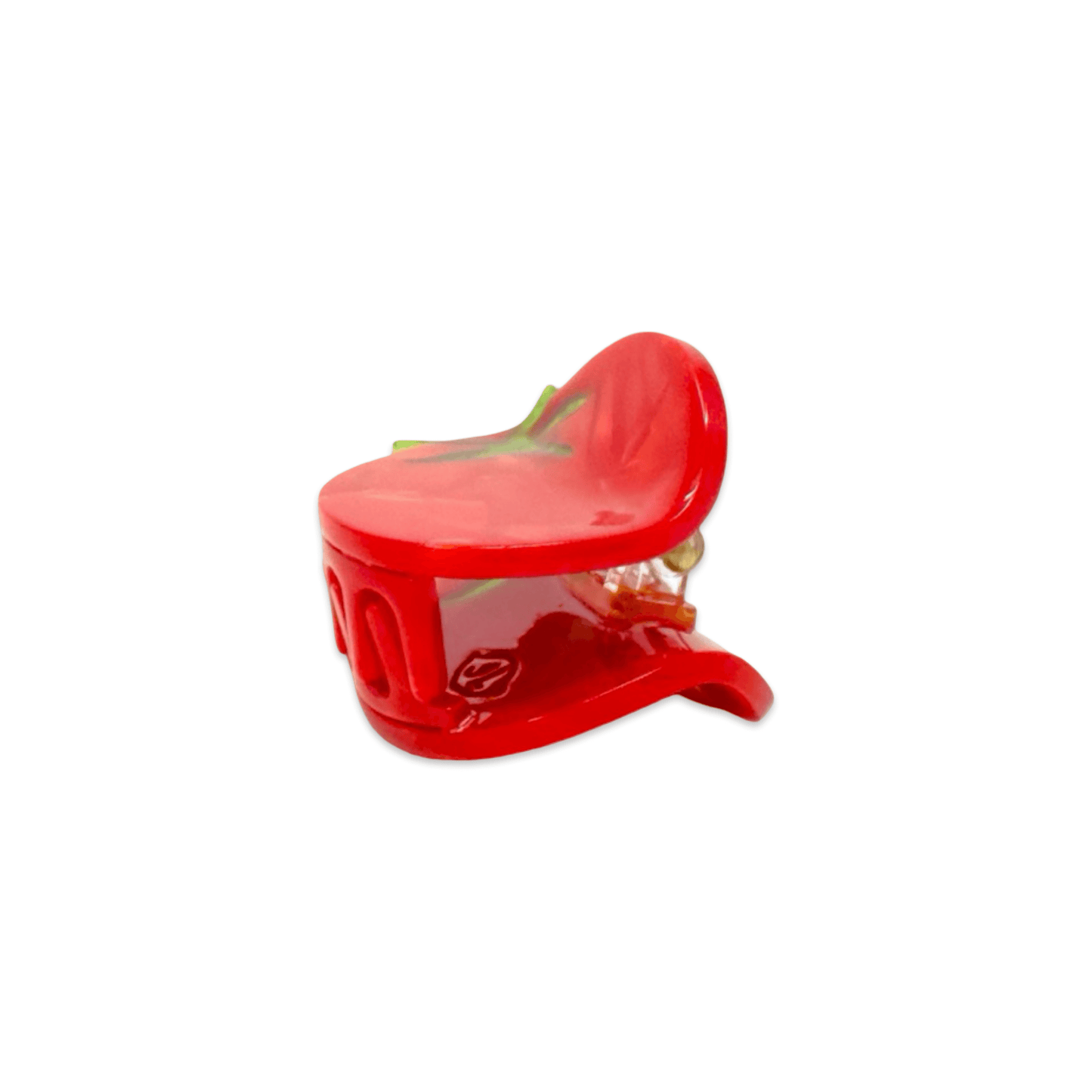 Red tomato shaped hair clip on a white background